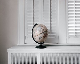 a globe sitting on an interior ledge by the window